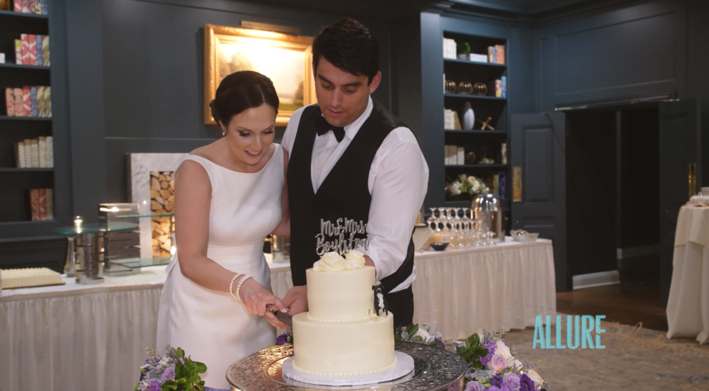 Geoff and Victoria happily cut their wedding cake inside of the Overbrook Golf Club Ballroom